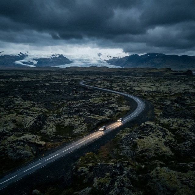 Test still of a winding road through dark volcanic ground